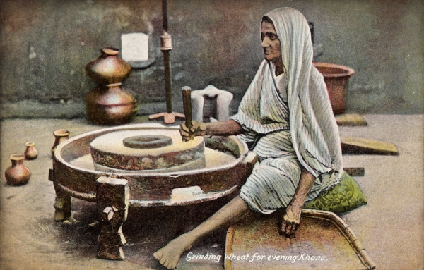 Using a quern or handstone, India 1909 (Postcard from the Mills Archive Collection, MCFC-10529)