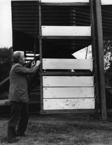 Frank adjusts the lever on one of the spring sweeps to keep the tension on the closed shutters