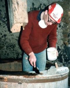 Painting wood preservative on vat at Heage Tower Mill
