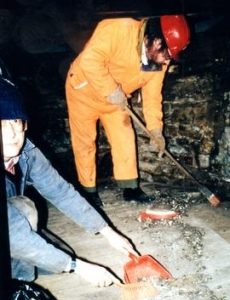 Cleaning debris on dust floor at Heage Tower Mill