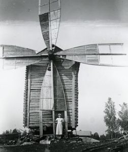 Toe mill in Taipalsaari, Karelia with a woman by the sails