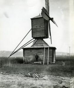 Chicken-hawk museum mill with a man in front in Kuortane, South Bothnia