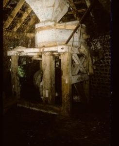 Pair of stones on hurst frame (hand mill?) within unidentified structure