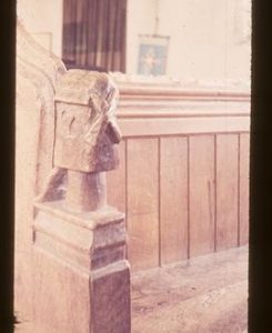 Bench end in church with carving of post mill
