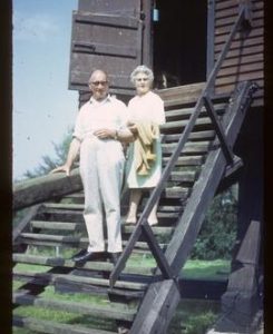 Millwright Edwin Hole and Mrs Hole, standing on ladder, post mill, Nutley