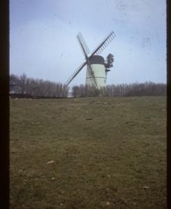 House-converted tower mill with sails
