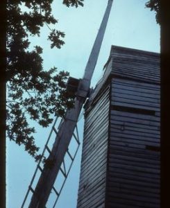 Close-up of stock, part of surviving sail and part of body of derelict post mill