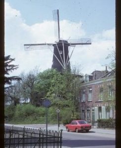 Tall preserved tower mill with sails and stage