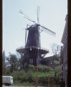 Tall preserved tower mill with sails and stage