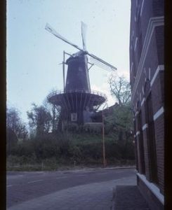Tall preserved tower mill with sails and stage
