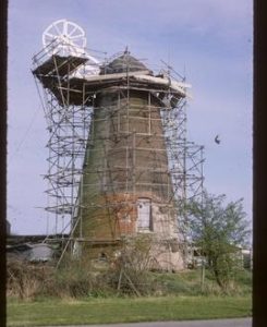Tower mill scaffolded for repair, with cap and fantail