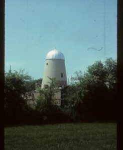 House-converted tower mill with replica ogee cap