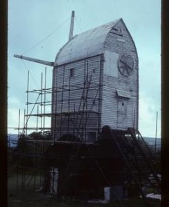 Jill Mill, Clayton, scaffolded for repair, with stocks