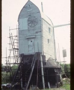 Jill Mill, Clayton, scaffolded for repair, with stocks