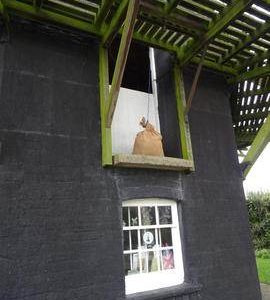 Exterior view of base showing loading door, smock mill, Herne