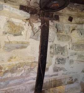 Truck wheel and iron strap, purpose unknown, in tower wall, Stembridge Mill, High Ham