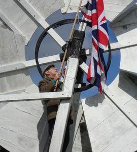 Fixing Union Jack to fantail, post mill, Holton St Peter
