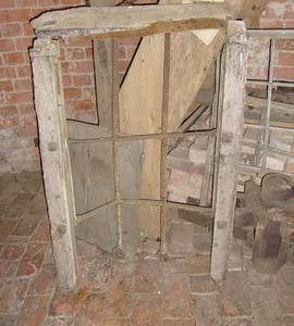Iron window frame preserved on ground floor, tower mill, Norton Lindsey