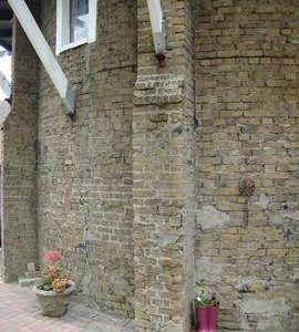 Buttresses on lower section of tower for supporting stage, tower mill, Stanford