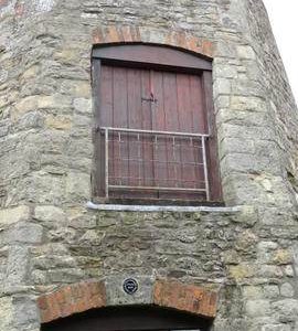 External view of tower showing loading door, Littleworth Mill, Wheatley