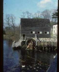 Exterior view of preserved watermill building with wheel, New York, Tarrytown, Philipsburg Manor