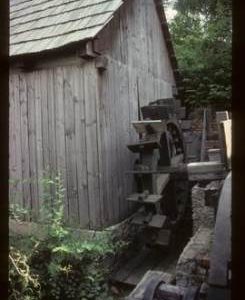 Exterior of preserved watermill building with wheel