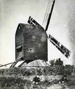 Post Mill with four sweeps and people in foreground