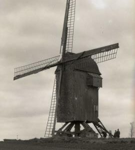 Post mill at Eperlecques, Pas de Calais, France (with 3 people and a tripod assembled at the base)